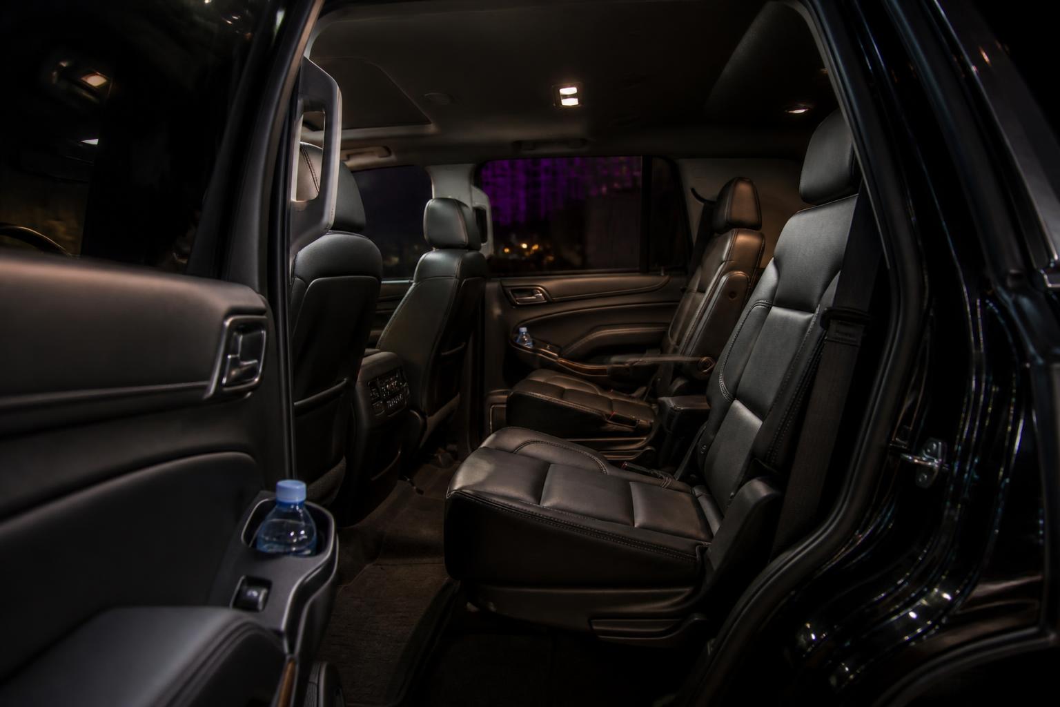 Immaculate black leather GMC Yukon rear cabin with captain's chairs